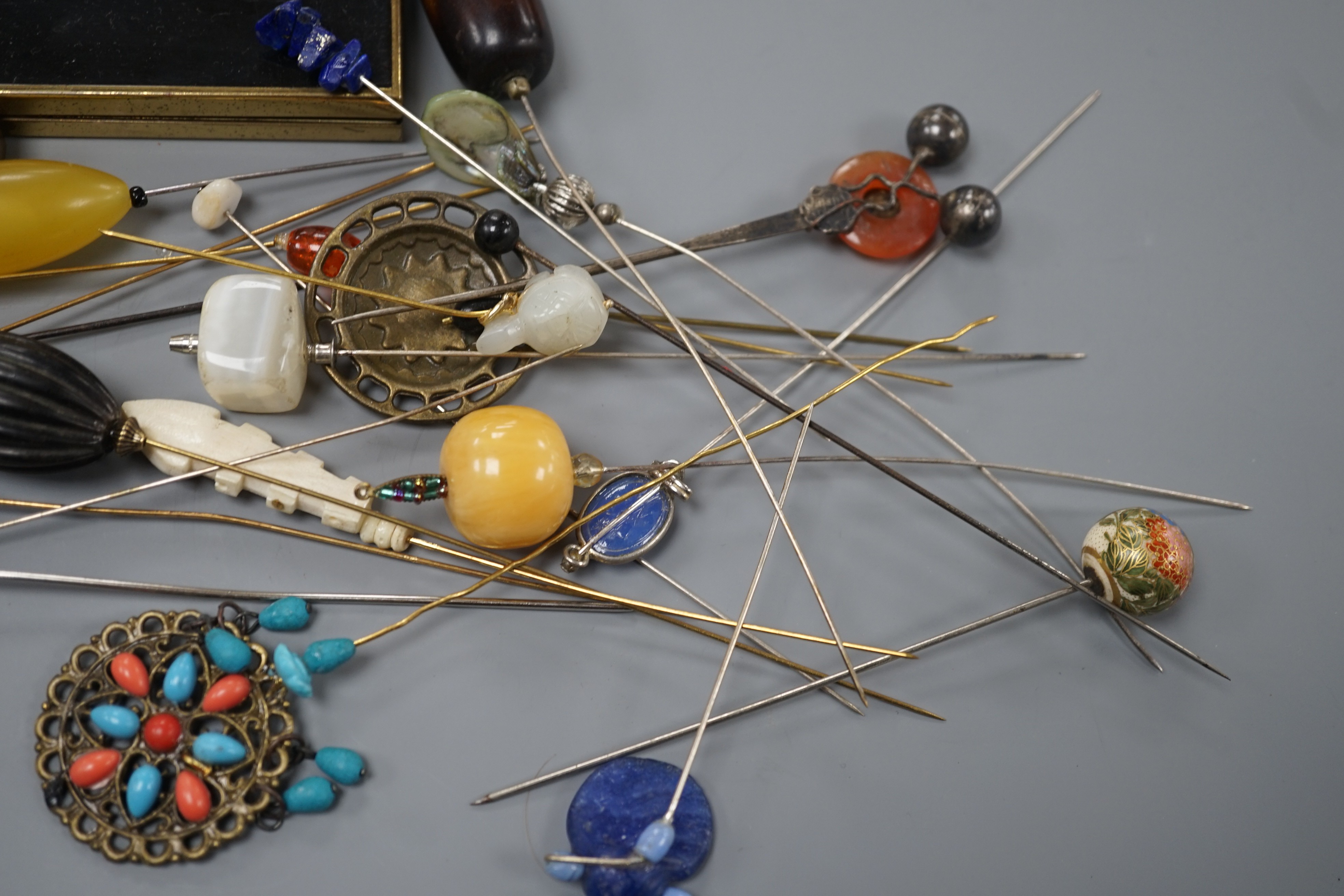 A quantity of hat pins and a compact
